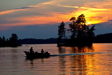 Fishermen on a Boat in the Water with Pretty Sky